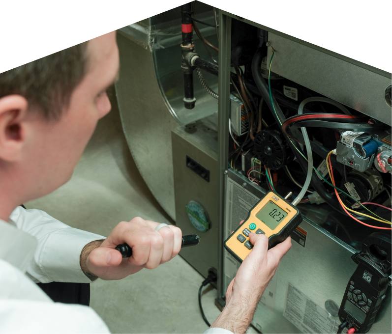 Mersey HVAC specialist performing furnace repair on a heating sy