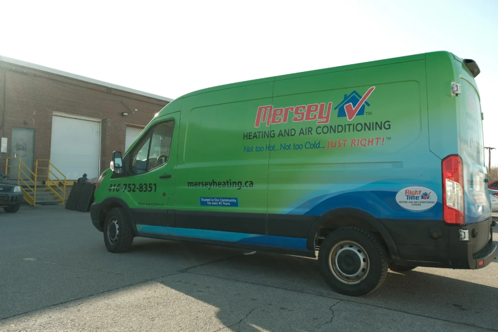 A Mersey Heating and Air Conditioning service van parked outside a building, ready to help GTA homeowners with fall furnace room safety checks.
