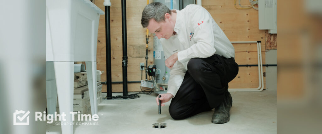 Plumber checking a floor drain during a plumbing emergency.